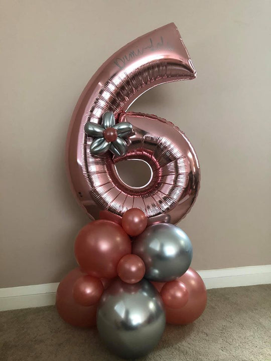 Personalised rose gold number 6 foil balloon with a silver balloon flower on a rose gold and metallic silver balloon base.