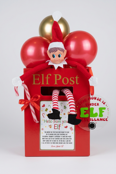 Elf on the Shelf in a red mailbox labeled 'Elf Post' with balloons in the background.
