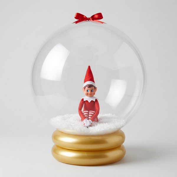 Elf on the Shelf inside a clear snow globe with a yellow base.