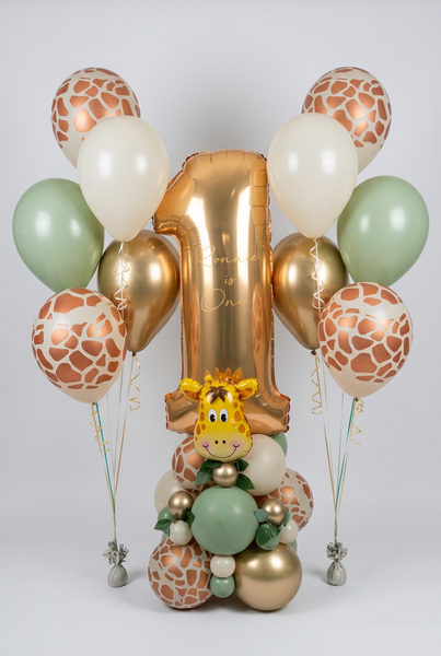 Personalised gold number 1 balloon with a giraffe-themed sage, cream and gold base, beside two matching five-balloon helium bouquets.