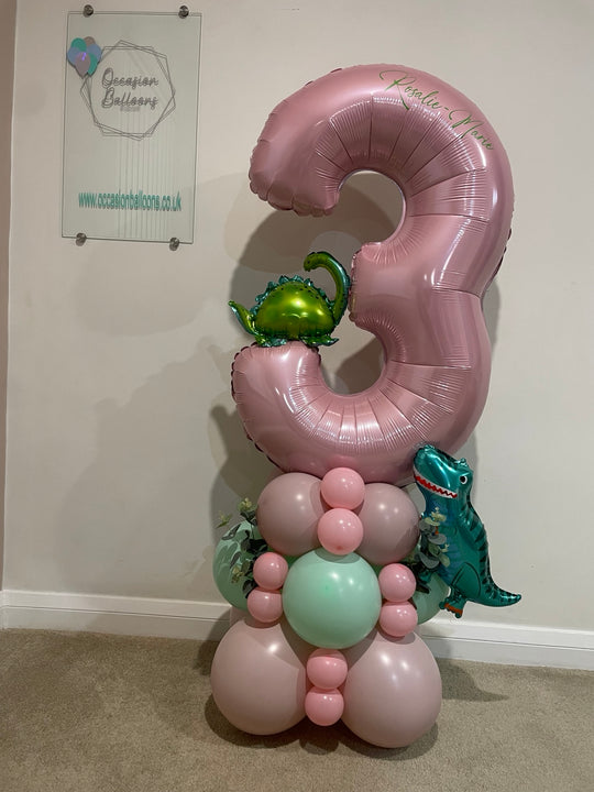  Personalised pink number 3 balloon with green dinosaur decorations and a pink and mint balloon base.