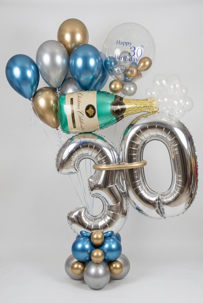 Silver 30 birthday number balloons with a blue, gold and silver base, champagne bottle balloon, personalised bubble balloon and matching helium balloons.