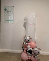  Personalised cow-themed birthday number balloons with a pink, white and cow-print base. Portland collection and local delivery available.