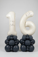 Personalised cream number 16 foil balloons on two charcoal grey balloon towers, with Happy Birthday wording and the name Ruby.