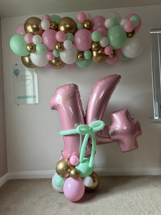 Personalised birthday number balloons with a matching garland in your chosen colours. Portland collection and local delivery and setup available.