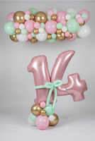 Personalised pink 14 balloons with a mint bow and pastel balloon base, beneath a matching pink, mint, white and gold balloon garland.