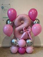 Pink number 8 balloon personalised with Rosie-Mae, with a satin bow, flowers, pink and silver balloon base and two matching helium bouquets.