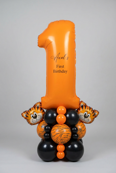 Orange number 1 balloon personalised for Axel’s first birthday, with two tiger balloons and an orange, black and tiger-print balloon base.