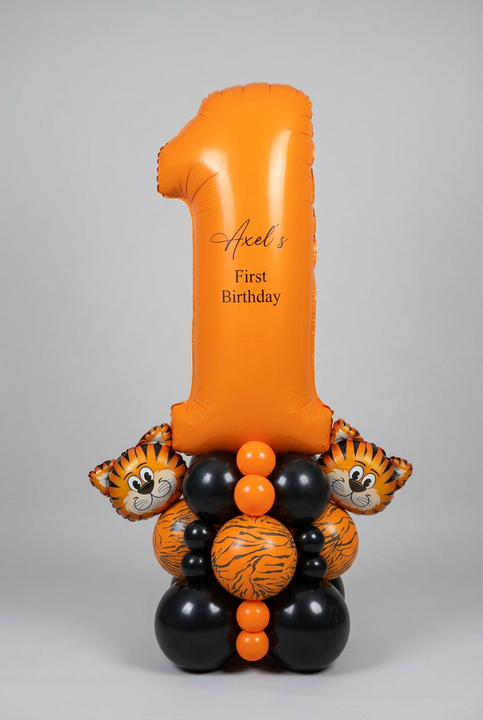 Orange number 1 balloon personalised for Axel’s first birthday, with two tiger balloons and an orange, black and tiger-print balloon base.
