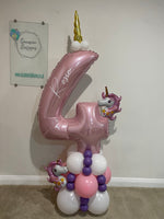 Pink number 4 balloon personalised with Rosie, topped with a gold unicorn horn, with two mini unicorn balloons and a pink, white and purple base.
