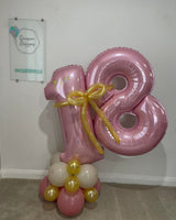 Personalised pink number balloons with a gold balloon bow and coordinating base. Collection from Portland and local delivery to Weymouth and Dorchester.
